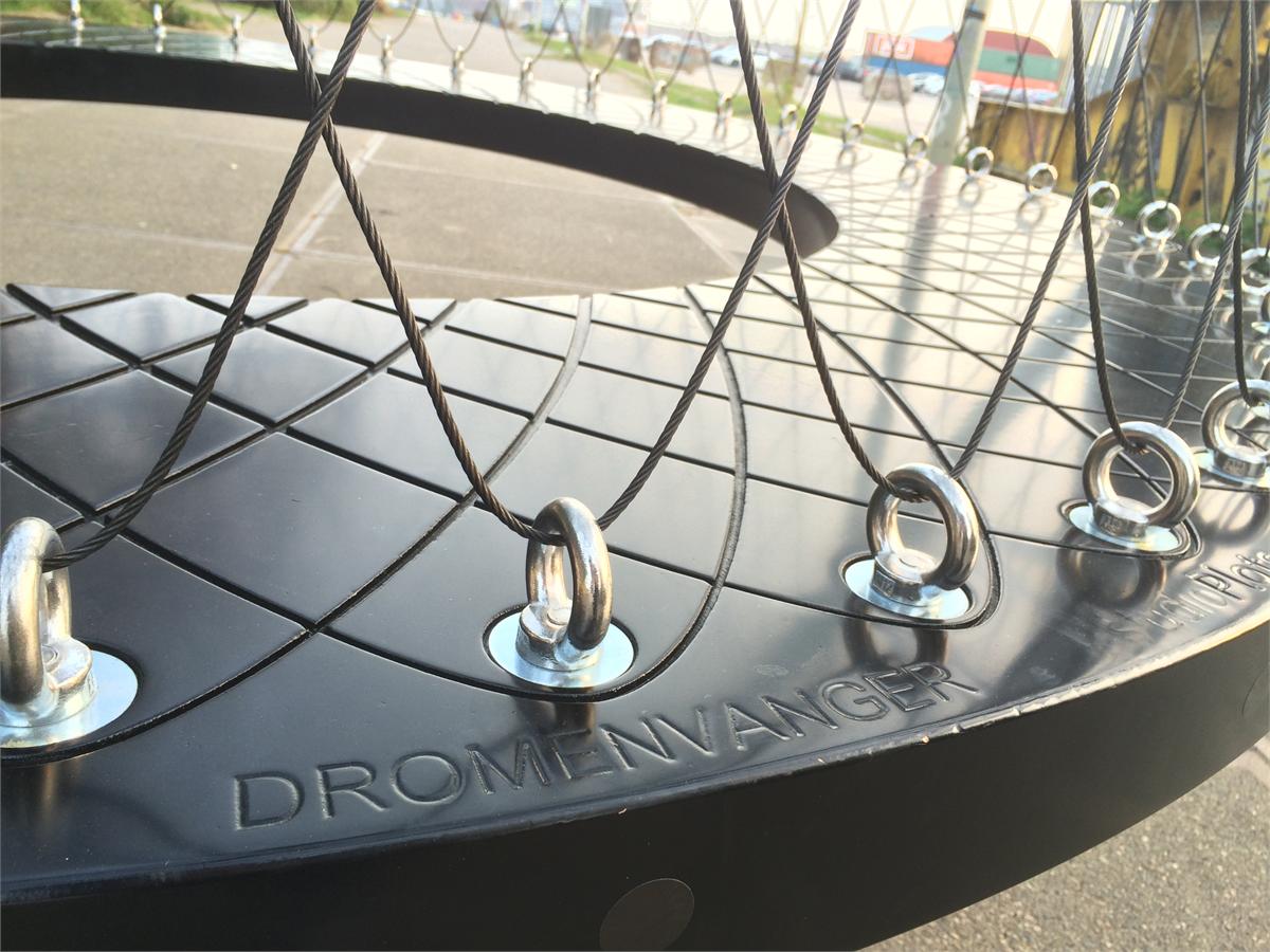 Detail of the timber lower ring with the word DROMENVANGER routed into it; stainless steel eye nuts along the edge hold the steel cables of the net.