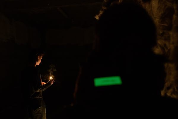Image 4: audience carrying a light.