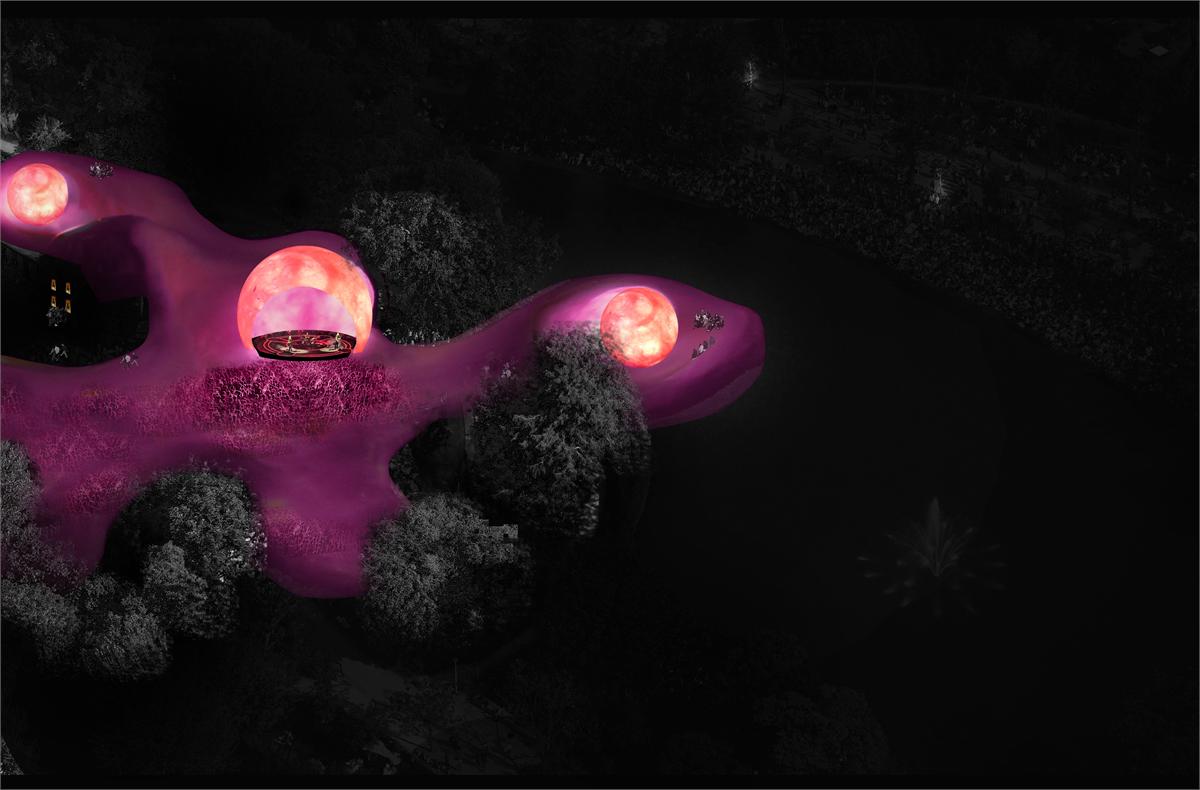 Night view from above: the pink form winds through the dark park with three glowing bowls set into it, one of them enclosing a lit arena.